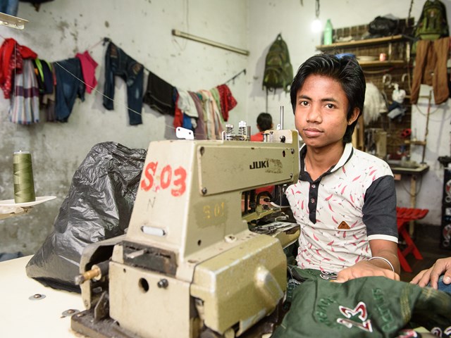 Boy working in sweatshop in Dhaka, Bangladesh